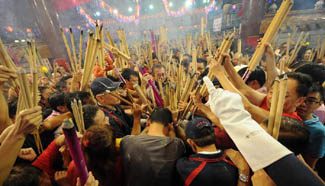 Ethnic Chinese pray for good fortune on Lunar New Year eve in Singapore