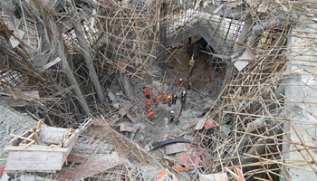 Two dead, seven trapped in central China's scaffold collapse